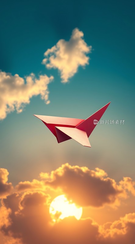 红色纸飞机翱翔在夕阳下的天空