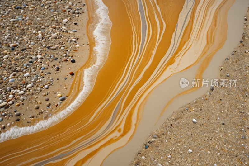 流淌的橙色液体在沙滩上卵石高清背景图片