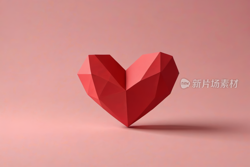 粉红色背景的红色爱心特写高清图片