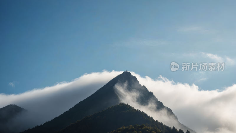 一座云彩覆盖在树上的高山清风景图片