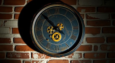 古铜色时钟映红砖墙