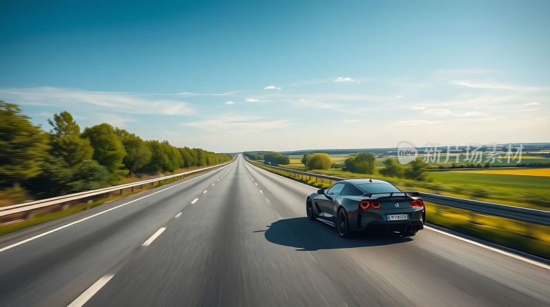 黑色跑车驰骋在绿意盎然的高速公路上