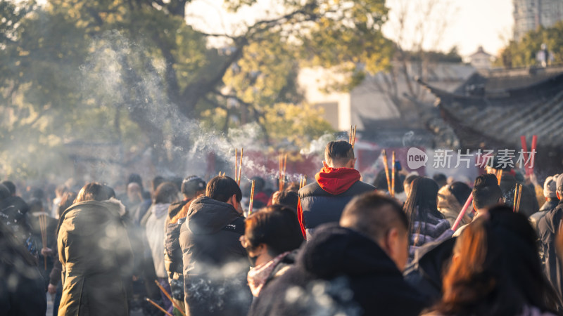 户外人群手持香烛烟雾缭绕的场景