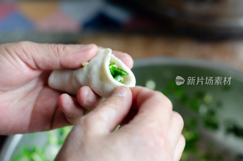 正在包韭菜鸡蛋饺子的女人的手特写