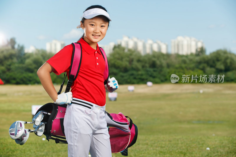 户外快乐儿童背着高尔夫球包