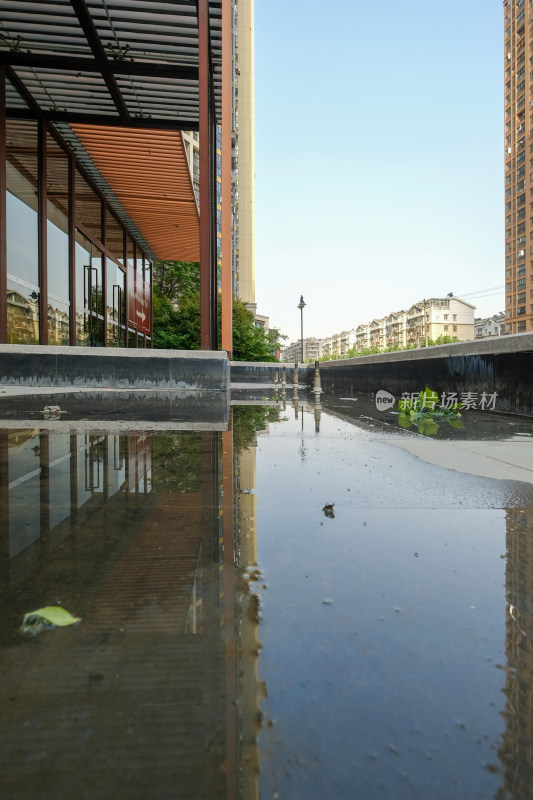 积水地面映出建筑倒影的城市街景