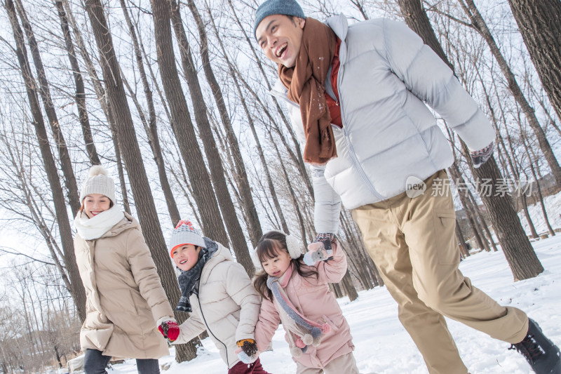 欢乐家庭在雪地里奔跑