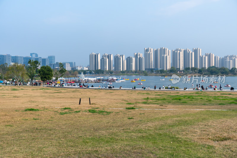 城市湖边休闲人群与高楼景观