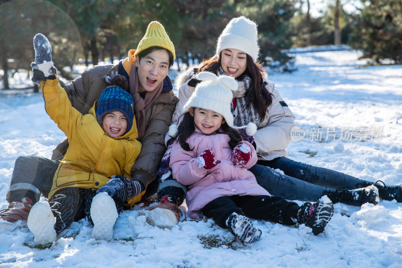 快乐的一家人坐在雪地上