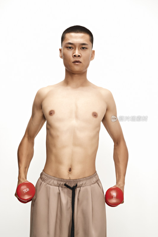 使用哑铃进行健身锻炼的亚洲男性
