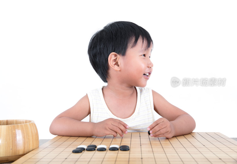 中国小女孩坐在棋盘前看向别处