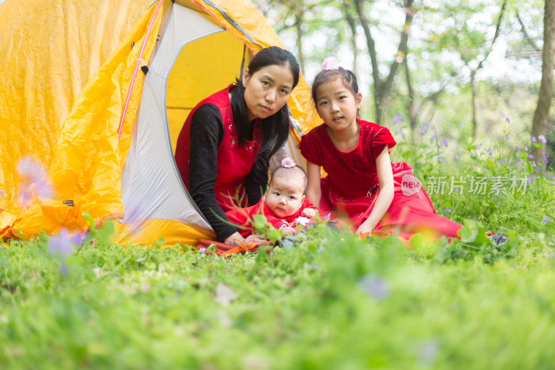 春天户外 年轻妈妈带两个孩子帐篷里看风景