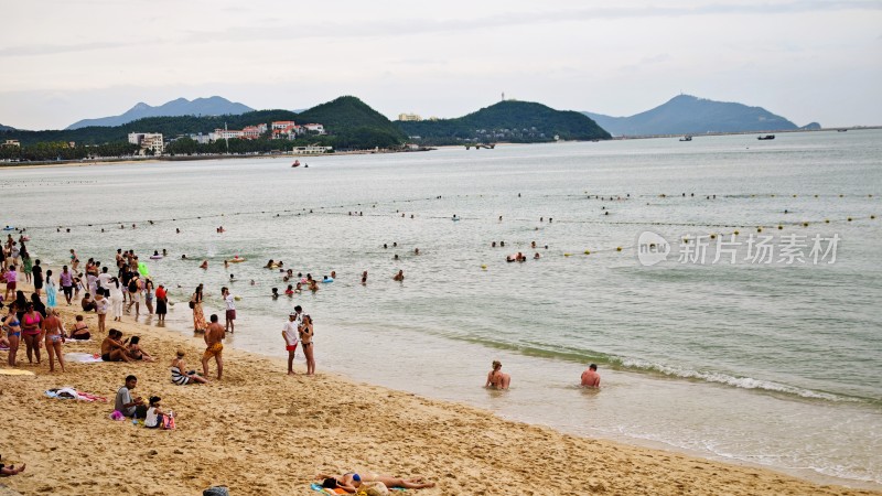 海南三亚大东海海滨浴场休闲游泳的人们