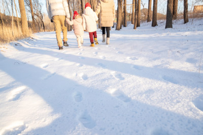 快乐家庭在雪地里散步