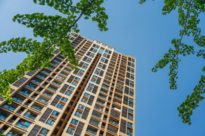 蓝天下低视角仰拍现代化住宅楼的画面