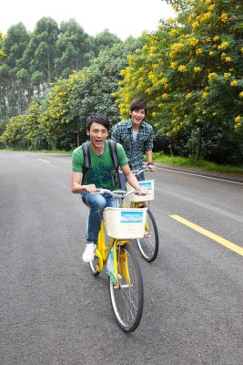 年轻大学生在校园里骑车