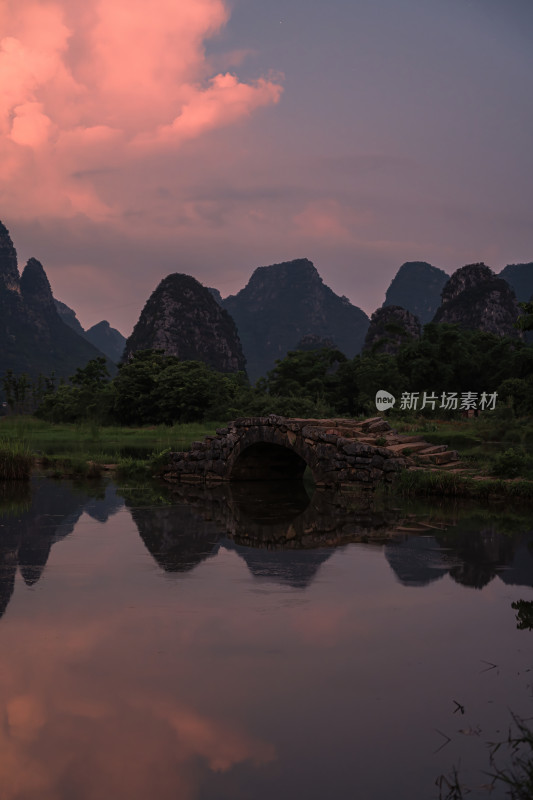 夕阳晚霞中桂林的山和河流上的石桥