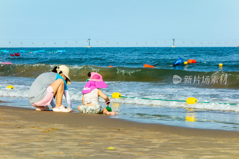 两个小女孩在南戴河海滨浴场沙滩上游玩