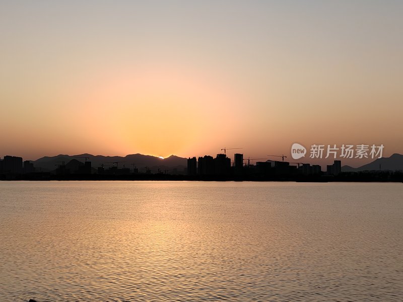 城市边湖面上的日落美景