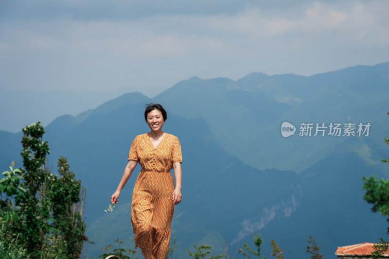 晴朗的夏天午后走在盘山公路上的中国女性