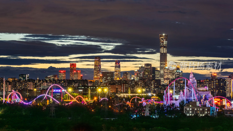 北京夜色过山车旁的繁华都市天际线