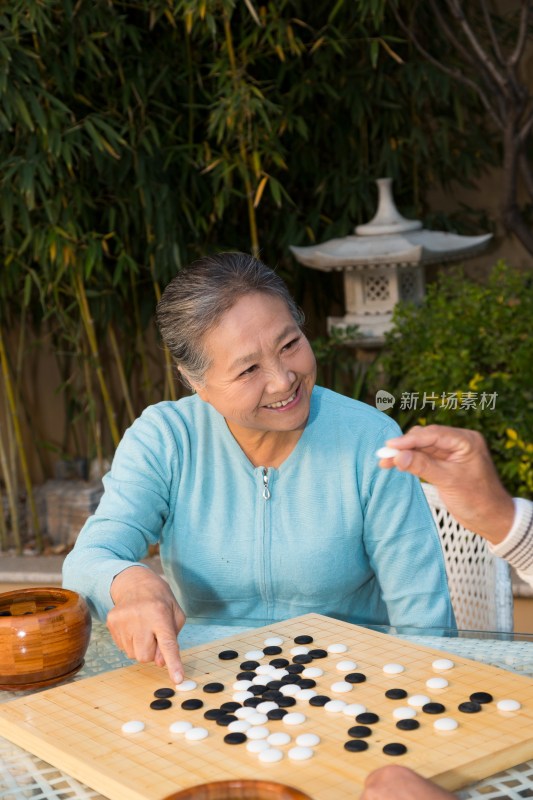 老年夫妻在院子里下棋