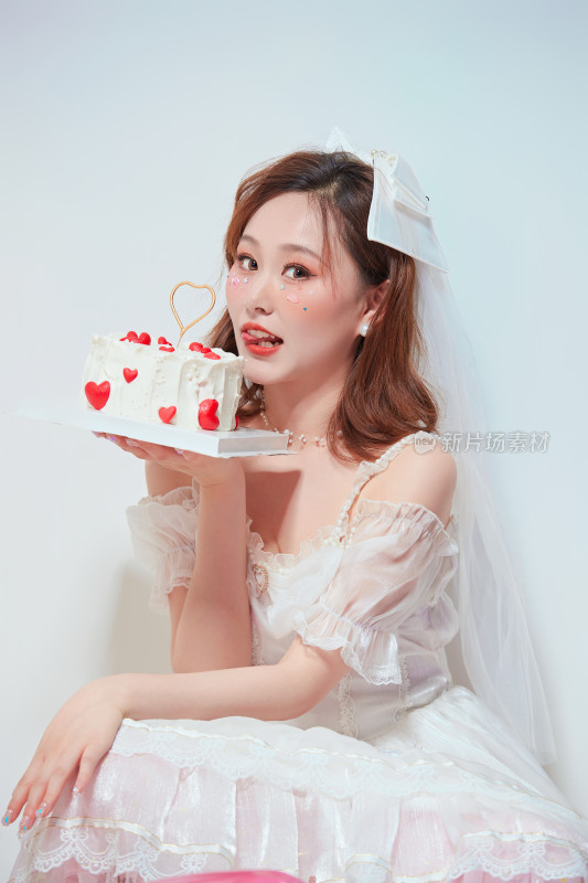 穿着公主裙手捧蛋糕庆祝生日的亚洲女性
