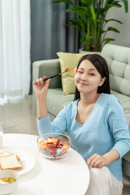 年轻女士在家吃水果沙拉