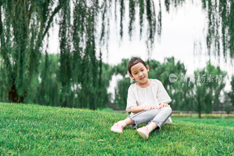 夏天坐在草地上的中国女孩