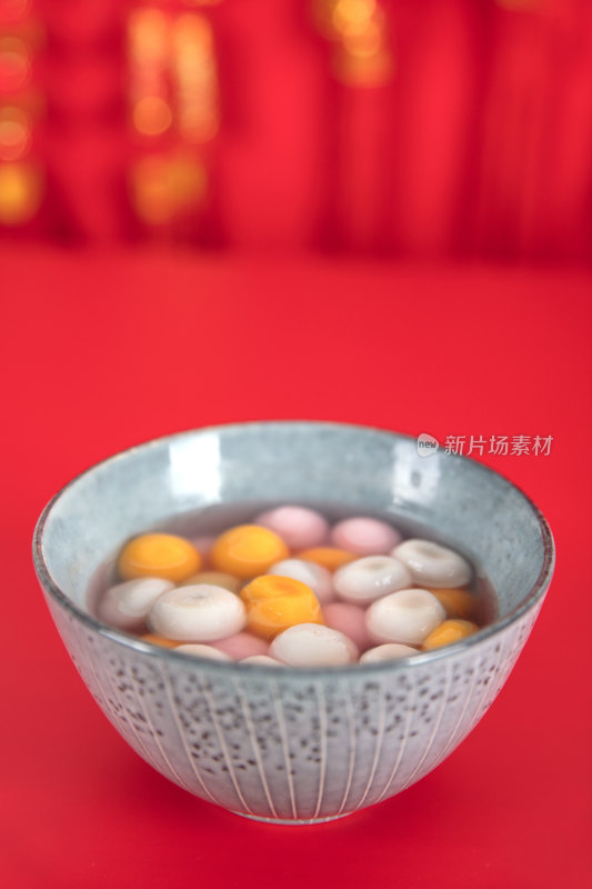 红背景上一碗元宵节的汤圆食品