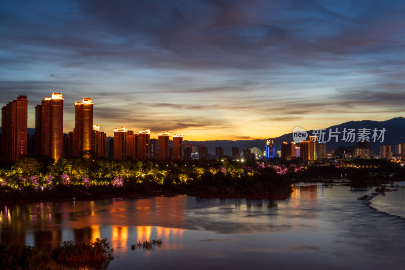 暮色下依山傍水的西双版纳多彩城市夜景