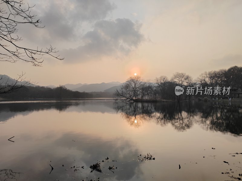 湖边日出美景倒映在平静湖面上