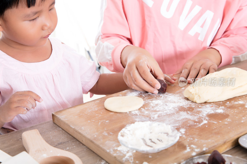 孩子在跟妈妈学习制作月饼