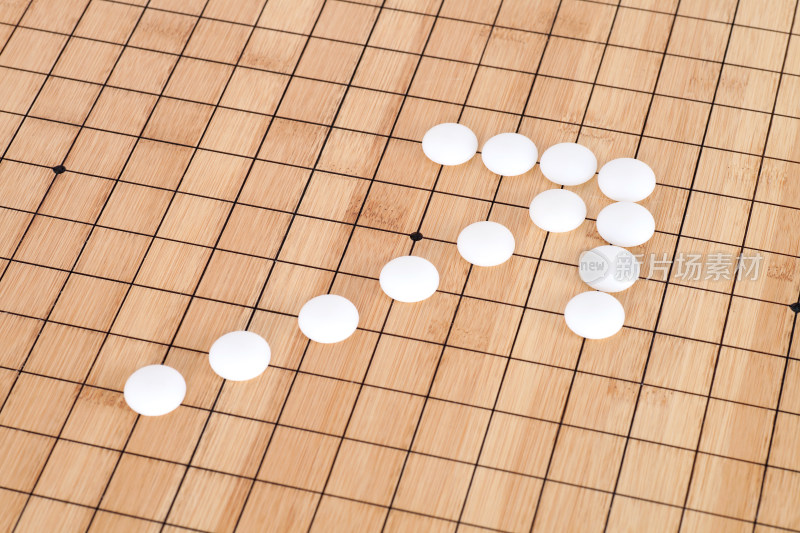 白色围棋子棋盘上组成的箭头符号