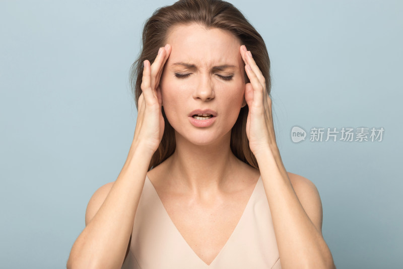 女性双手抱头显苦恼