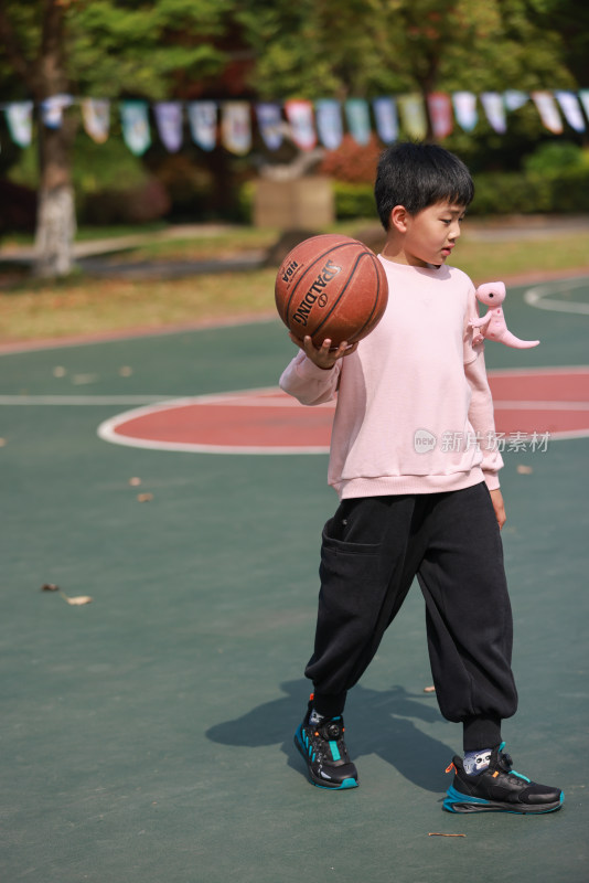 亚洲男孩在校园里练习打篮球