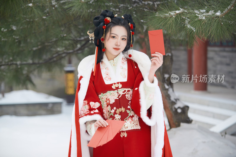 雪天户外身穿中式红色汉服的亚洲少女