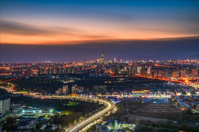 夜幕中的北京繁华立交桥与摩天大楼的光影