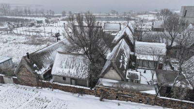 航拍山东荣成马山寨村海草房冬季雪后景观