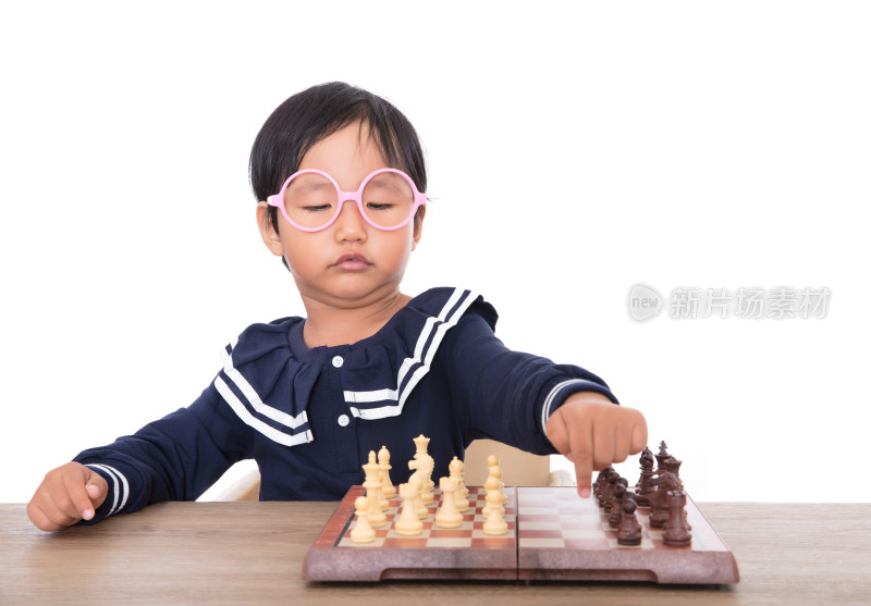 戴着眼镜框可爱的小女孩在下国际象棋