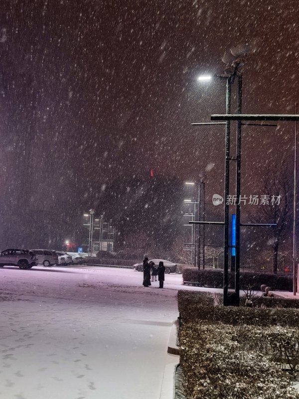 夜晚户外行人雪中漫步场景