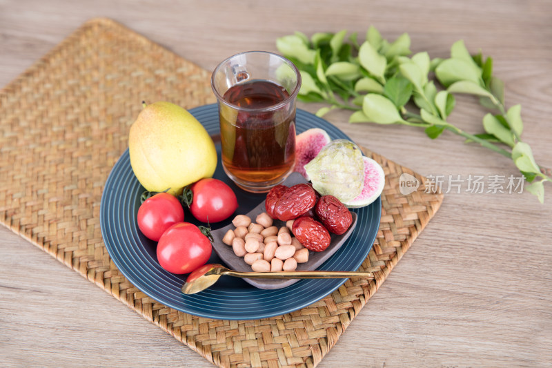 盘子里一杯红茶和各种茶品零食