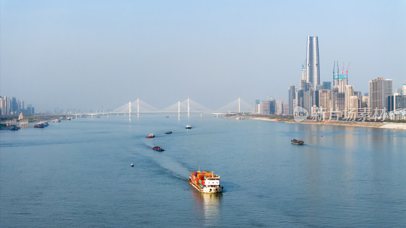 城市江面上的货船与沿岸高楼景观