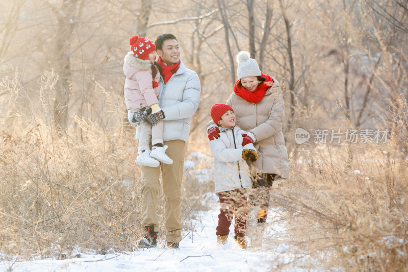 快乐家庭在雪地里散步