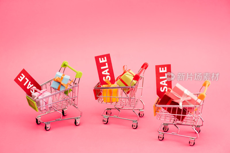 粉色背景购物车礼品促销素材