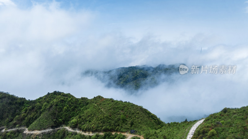 阳光下桂林高山上的云雾缭绕和风力发电设施