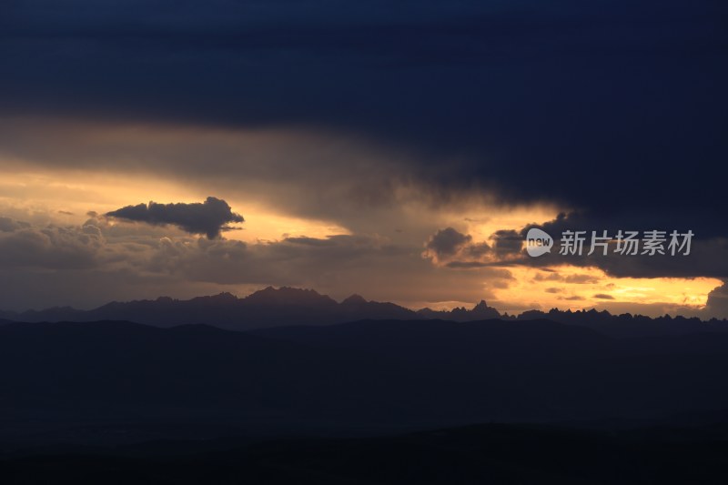 山峰日落时天空映衬的剪影景观