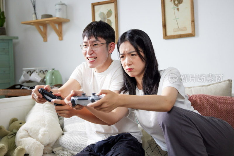 年轻情侣在家里玩游戏