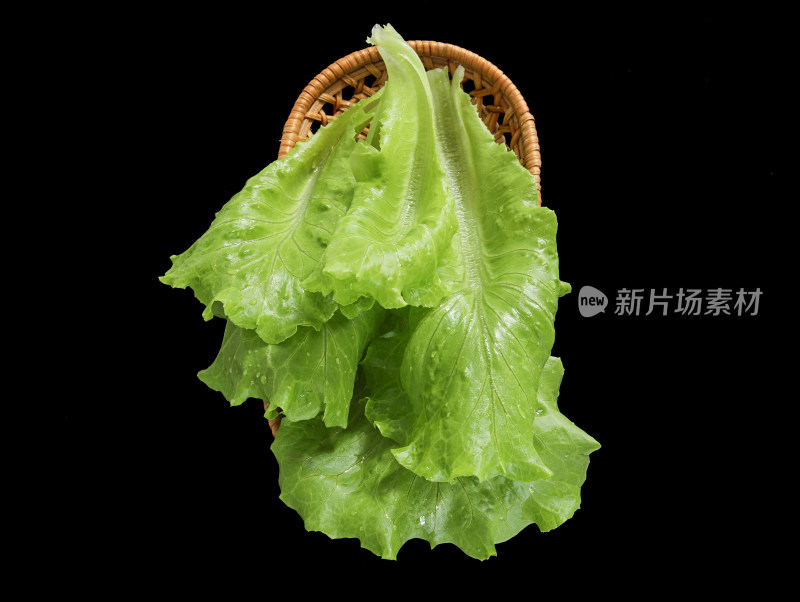 黑色背景上一篮子的新鲜绿色蔬菜生菜