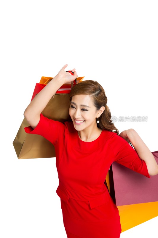 棚拍红裙子的年轻女人提着购物袋